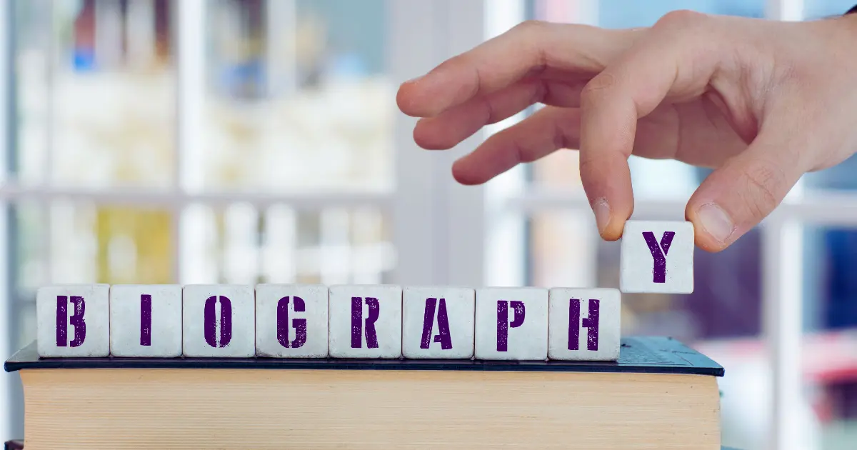Coach writing a professional bio with AI tools on a laptop